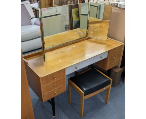 A retro Meredew light oak dressing table having three mirrors above seven drawers, 119cm h x 129.5cm wLocation: 