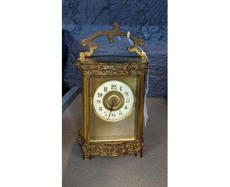A 20th century brass cased carriage clock with pressed ornament Location: 