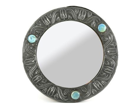 Early 20th C pewter mirror with decoration of stylised flowers and three Ruskin ceramic roundels  .  