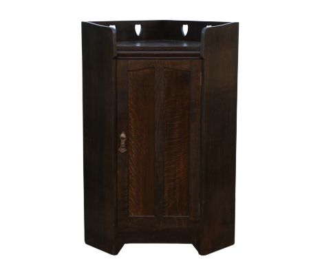 Liberty &amp; Co, oak floor standing oak corner cabinet,  with pierced heart motif, single door, ivorine label Liberty &amp; 