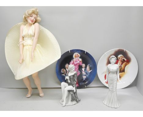 A collection of Marilyn Monroe items including a set of 14 collectors plates, a sheet of stamps, two bisque models and a larg