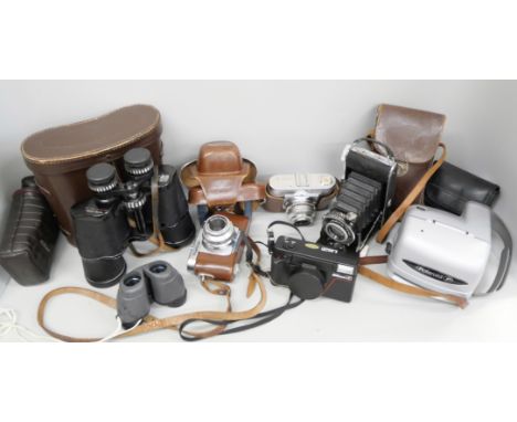 Two Voigtländer Vito B cameras, an Agfa folding camera, a Polaroid land camera, a pair of Prinzlux 10 x 50 binoculars, a Niko