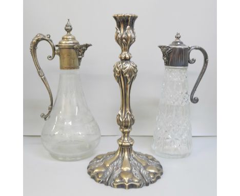 Two claret jugs, one with etched glass and inner stopper, and a candlestick with leaf detail, candlestick 31cm