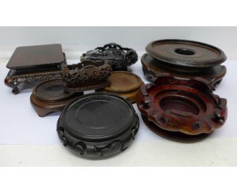 Nine carved stands for oriental vases or jade carvings, some a/f