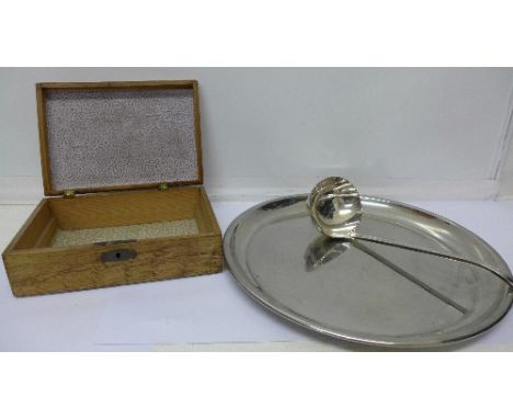 A ladle, a plated tray and a wooden box