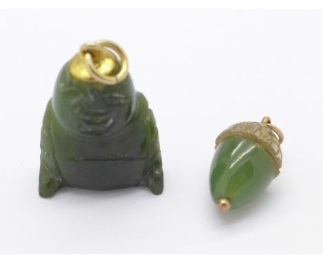 A Buddha pendant and a jade acorn pendant