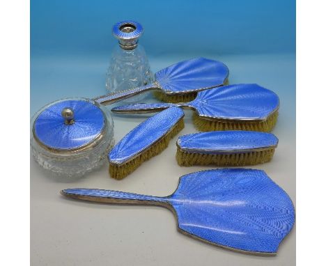 A silver dressing table set with blue guilloche enamel, lacking bottle stopper, enamel a/f on brushes