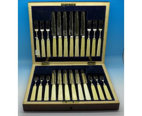 A cased twenty-four piece silver plate and ivory dessert knife and fork set