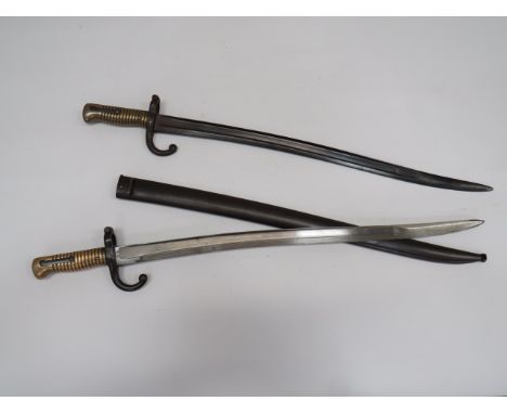 Two French Chassepot Sabre Bayonets22 3/4 inch, single edged Yataghan blades.  The back edges dated “1870” and “1868”.  Steel