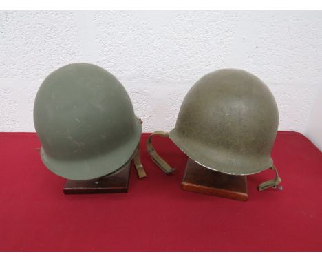 Two American Forces Steel Helmetconsisting green, rough texture helmet.  Front seam.  Swivel side bails holding the green web