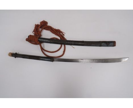 19th Century Burmese Dha Sword21 1/4 inch, single edged blade widening towards the point.  Tubular wooden grip with silver sh