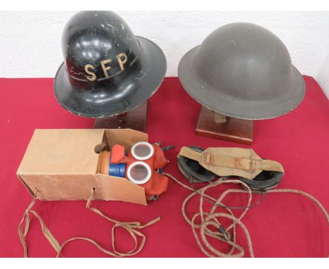 Small Selection of Helmetsconsisting WW2 British, black painted MKII helmet.  Treated linen liner.  The frame dated “1942”.  