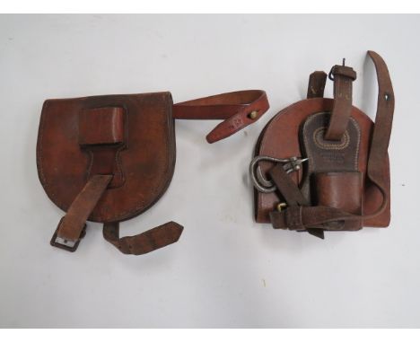 Two Horseshoe Casesconsisting a pre WW1 example.  Tan leather with internal nail case.  Removable front sword frog with “Wals