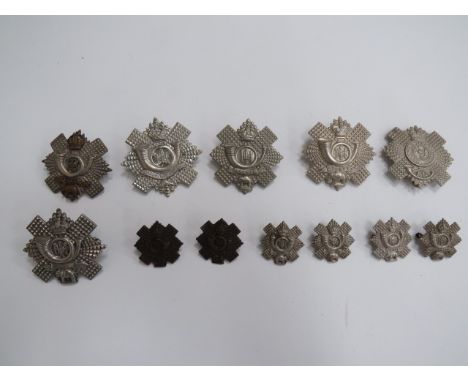 Small Selection of Highland Light Infantry Badgesincluding Tudor crown, white metal 5/7/8 Batt, blank scroll ... KC white met