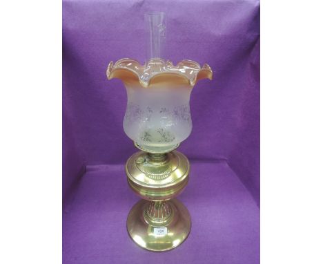 A 19th century brass frame oil lamp having later fluted shade