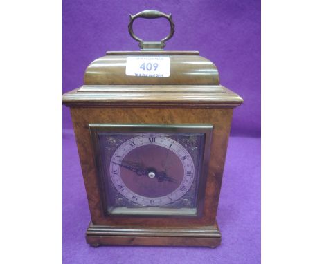 A 20th century walnut case Elliot mantel clock in the 18th century style having brass handle and bun feet