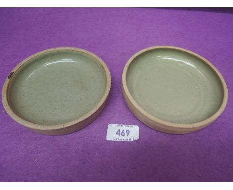A pair of St Ives pottery dishes by Bernard Leach having green glaze and with seal mark