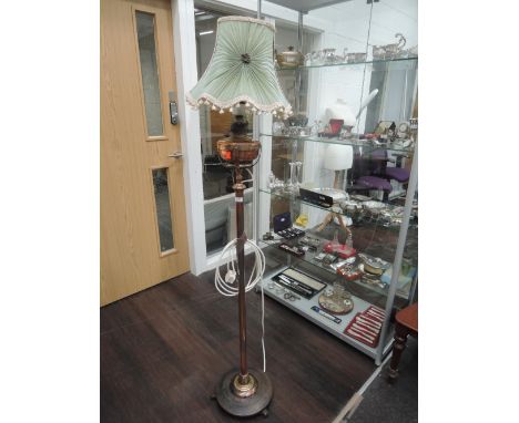A late Victorian/Edwardian copper and brass adjustable torchere oil lamp stand, later converted to electric, on circular base
