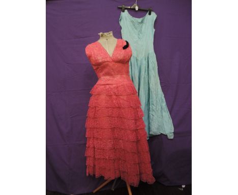 Two vintage items, a pink lace dress with black velvet bow detailing to shoulder, and a  full length blue under slip, could b