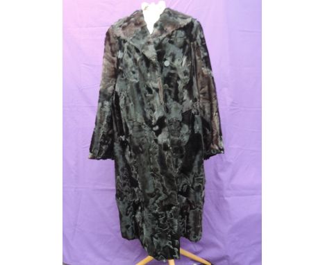 An unusual black fur coat, having shawl collar and button to front. Around 1950s , great condition, medium size.