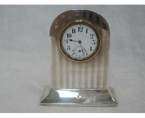 A small silver cased mantle clock of dome form having engine turned stripe decoration, Sheffield 1917, Walker &amp; Hall