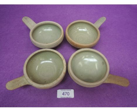 A set of four St Ives pottery wine tasters by Bernard Leach having green glaze and with seal mark