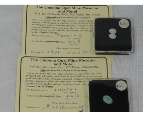 A pair of oval opal stones and another single opal stone with original purchase certificates from the Umoona opal mine Austra