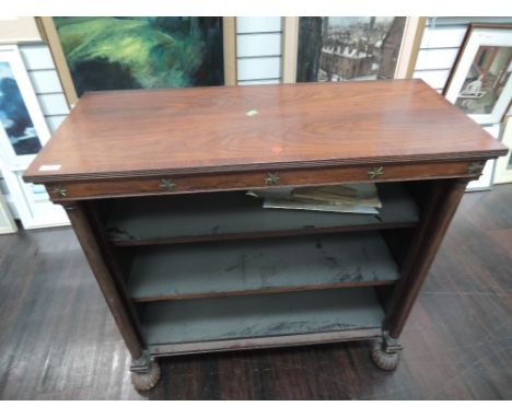 A 19th century mahogany bookshelf of Regency design having brass star applique with adjustable shelf flanked by turned pillar