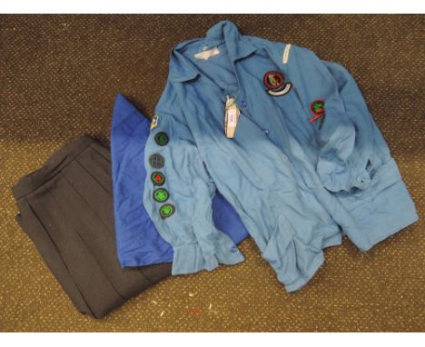 A vintage girl guide uniform, comprising skirt, blouse, neckerchief and knife. Good condition, some age related wear