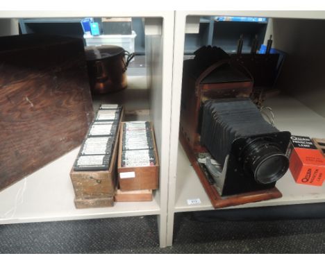 An early 20th century mahogany cased magic lantern of electric variant with Osram lamp and a selection of glass slides of geo