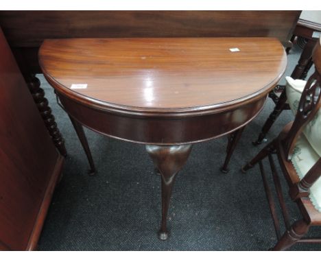 A mid 21st century stained frame demi lune card table having lift top and pull cabariole legs