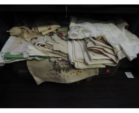 A selection of antique and similar table linen and bedding in vintage suitcase