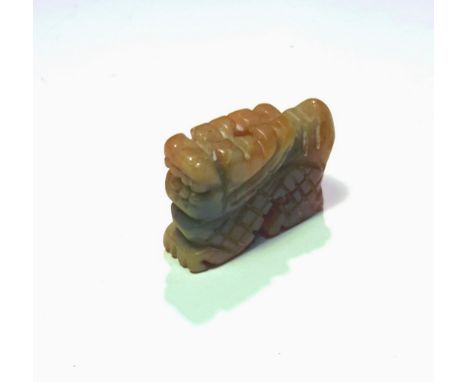 A celadon and russet jade netsuke.