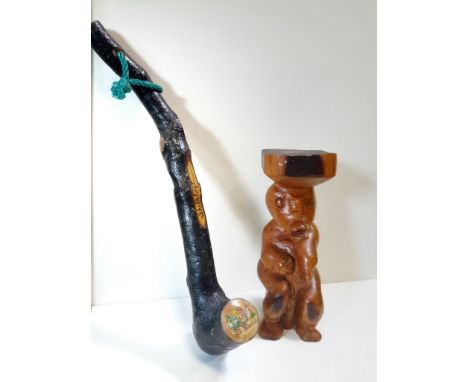 A decorative Shillelagh with a carved stool shelf.