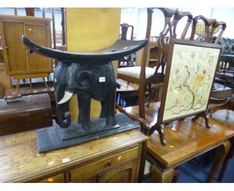 A CARVED ELEPHANT SEAT, and an oak framed firescreen (2)