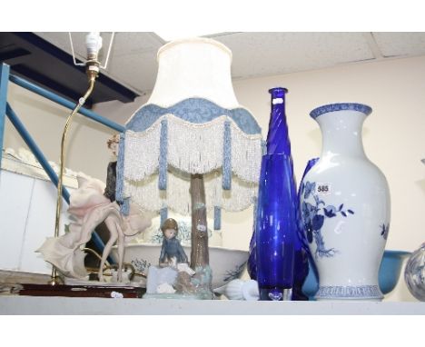 A NAO TABLE LAMP, seated girl with Rabbits, with shade, another table lamp, figure struggling with umbrella in wind and vario