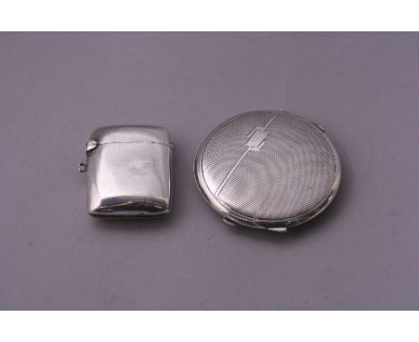 A SILVER VESTA, of plain form with strike to base, Chester 1904, together with a circular engine turned compact, Birmingham 1