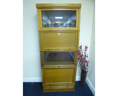 A LIGHT OAK PART GLAZED FOUR SECTION BOOKCASE/CABINET, with drawer below, approximate size width 80cm x depth 37cm x height 1