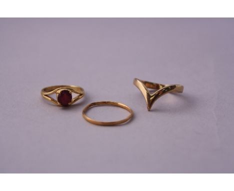 THREE RINGS, to include a ruby ring, wishbone ring and a band ring, ruby sd, stamps 18ct and 9ct Gold to two rings