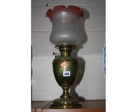 A BRASS OIL LAMP, with glass shade