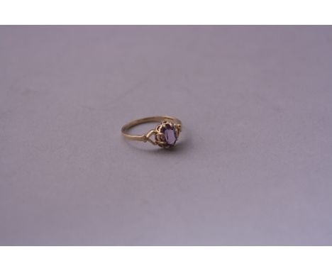 A 9CT GOLD AMETHYST RING, oval shaped faceted amethyst, with fancy scrolling tapered shank, hallmarks for London, ring size N