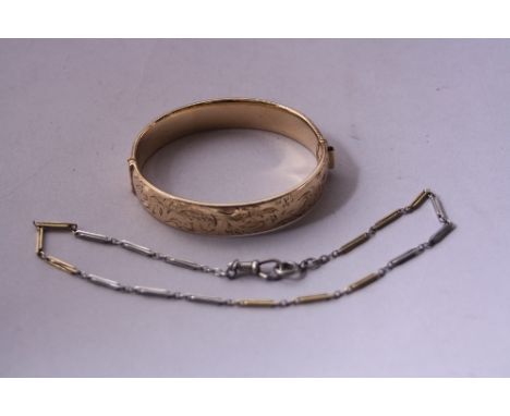 A 9CT GOLD METAL CORE BANGLE, together with a fancy chain (2)