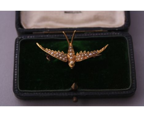 A PEARL BROOCH, in the shape of a swallow, one pearl deficient, within fitted box