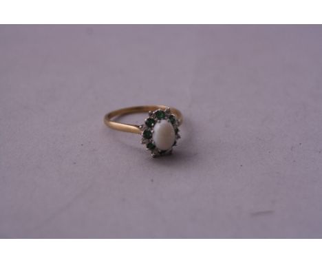 A 9CT GOLD OPAL RING, centre stone set with diamonds and emeralds, ring size T