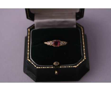 A RUBY RING, with central ruby and brilliant-cut diamond accents, stamped 18ct, ring size S
