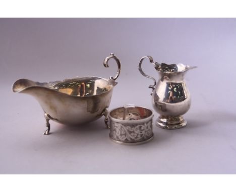 A SMALL SILVER SAUCE BOAT, with wavy rim on four feet, Birmingham 1913, 2.4oz,  a small silver cream jug,Sheffield, 1.7ozt an