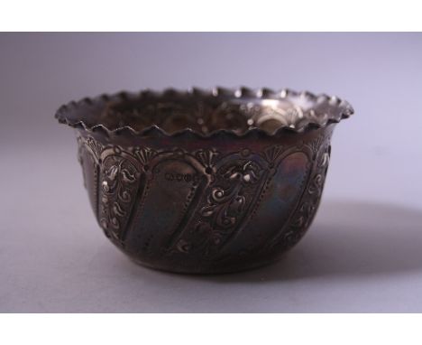 A SILVER SUGAR BOWL, with folded rim over relief floral decoration, London 1889, approximately 12cm diameter x 6cm high, 4.7o