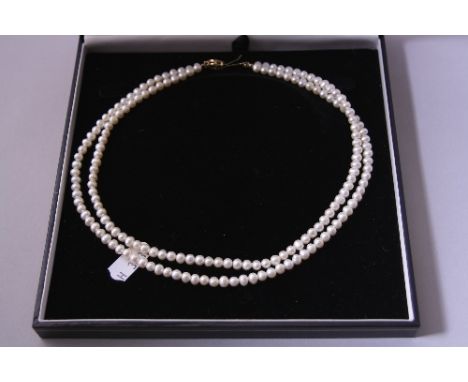 A PEARL NECKLACE, two rows of cultured pearls, 9ct gold clasp with diamond detail, hallmarks for London, length 45cm