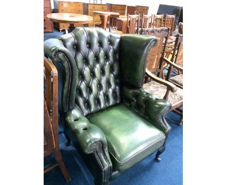 A green button back Chesterfield armchair