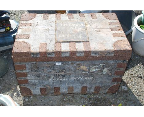 A metal bound trunk and contents including; wooden tripod, jack planes, etc.